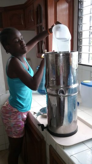 3. Chineca adding water to the drinking water filter